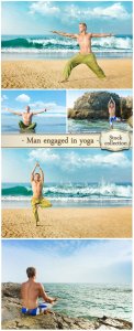  Man engaged in yoga on the beach - stock photos 